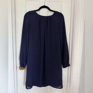 Lightweight navy dress, long sleeves.